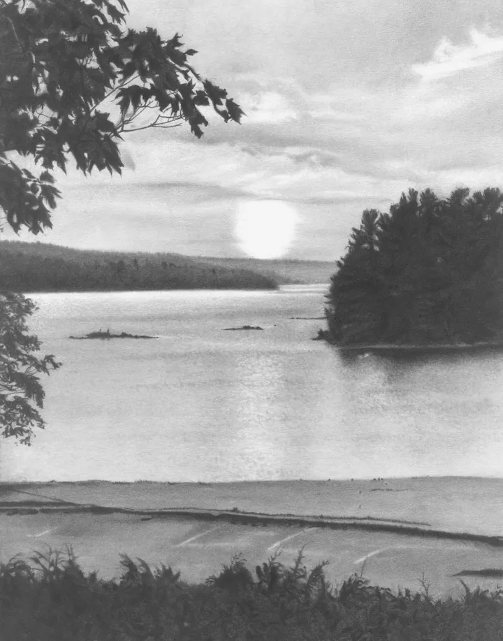 A bright sun lowers over calm water and distant hills, framed by dark shoreline trees.